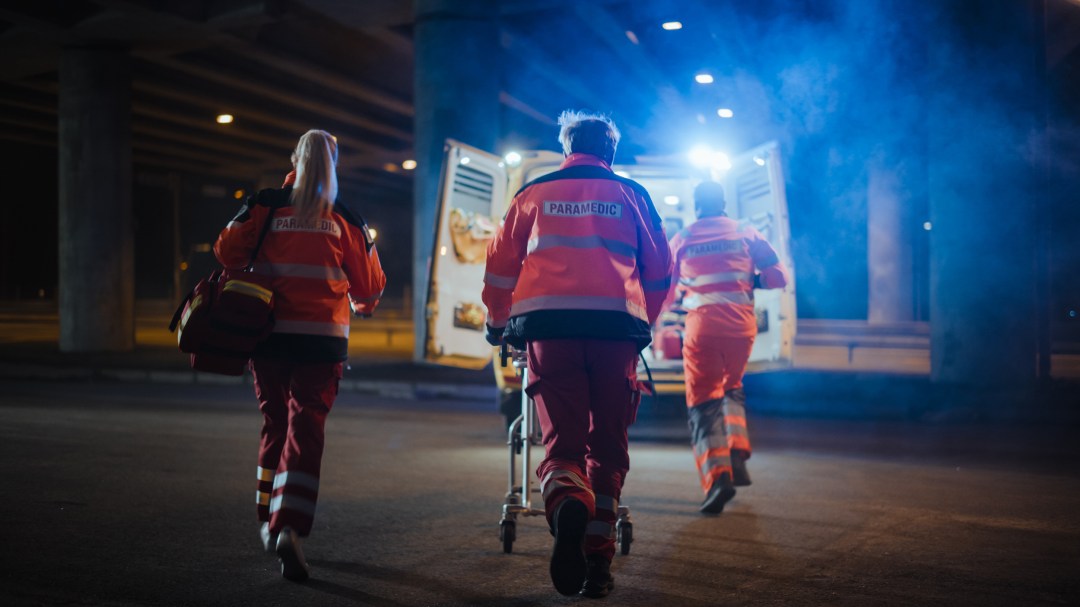 EMS paramedics provide assistance A team of EMS paramedics provide assistance to a patient