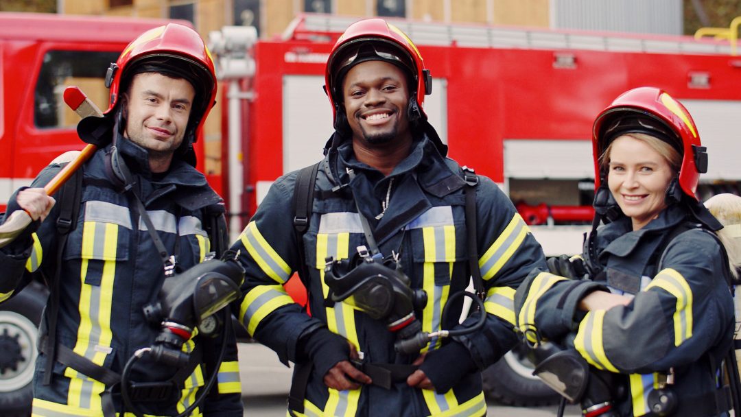 Firefighters in protective suits Firefighters wear protective suits with oxygen masks and helmets after fire fighting operation.