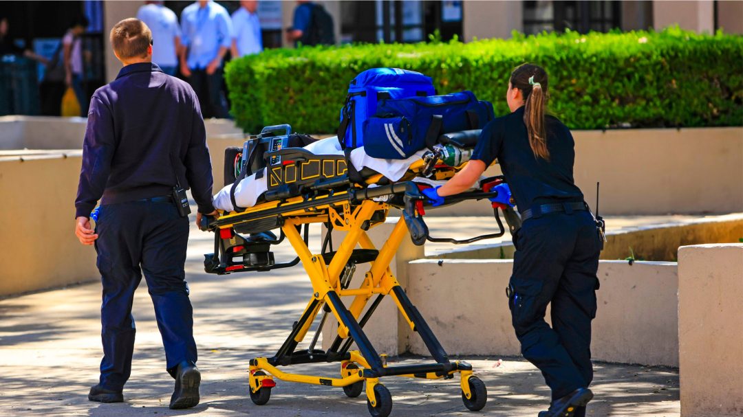 Paramedics pushing gurney Paramedics pushing a gurney loaded with life saving equipment